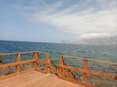 a view of the ocean from a wooden deck at Aura azzurra in Carini