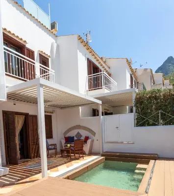 a villa with a swimming pool and a house at Anemos Apartment - Villa Sole in Macari