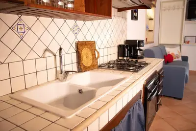 a kitchen with a sink and a stove at Anemos Apartment - Villa Sole in Macari