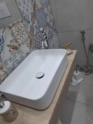 a bathroom with a white sink on a counter at Maddy Luxury Apartment in Palermo