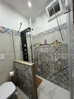 a bathroom with a shower and a toilet at Maddy Luxury Apartment in Palermo