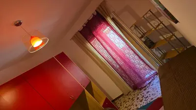 a room with a window with a colorful curtain at Casa U' Rittu Filu in Bagheria
