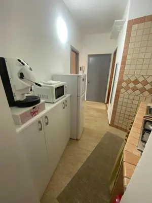 a kitchen with a microwave and a refrigerator at I Vicini di Ballarò in Palermo