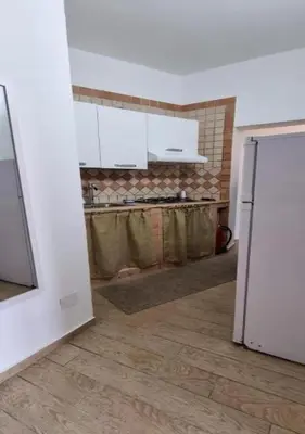 a kitchen with a white refrigerator in a room at I Vicini di Ballarò in Palermo