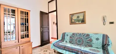 a living room with a chair and a window at Casa De Gasperi in Castellammare del Golfo