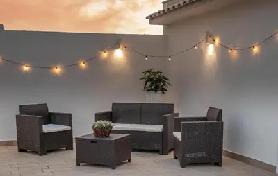 a patio with chairs and a table and lights at Beautiful Apartment In Balestrate in Balestrate