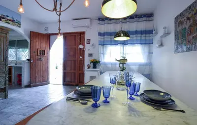 a dining room with a table with glasses on it at 3 Bedroom Lovely Apartment In Trappeto in Trappeto