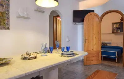a living room with a table with blue glasses on it at 3 Bedroom Lovely Apartment In Trappeto in Trappeto