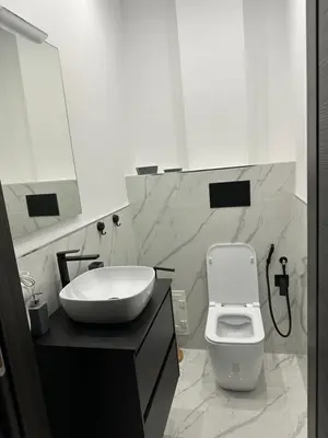 a white bathroom with a sink and a toilet at Luxurymimi in Palermo