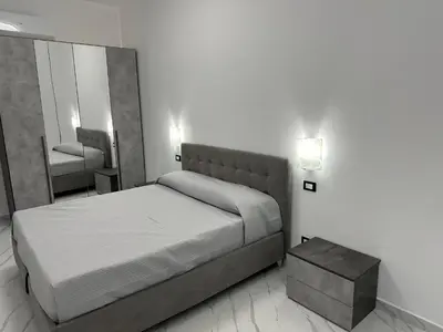 a bedroom with a bed and a mirror at Luxurymimi in Palermo