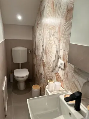 a bathroom with a toilet and a sink at Helios Apartaments in Cinisi