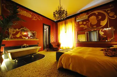 a bedroom with a bed and a bath tub at Sultan Suites in Palermo