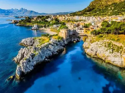 an aerial view of a town on the water at Giomasue' in Porticello