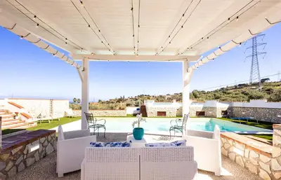 a patio with a table and chairs and a pool at Villa Casty with private pool in Trabia