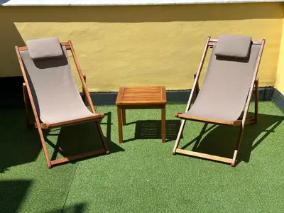 two chairs and a wooden table in a room at Mahalo in Palermo
