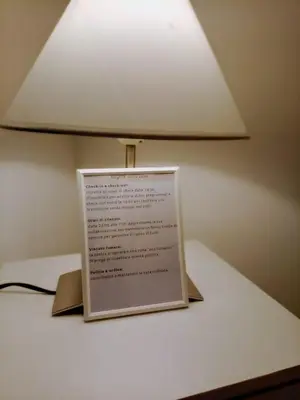 a lamp on a table with a sign on it at Tiny Home Di Carlo in Palermo