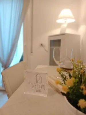 a tiny home sign on a table with flowers at Tiny Home Di Carlo in Palermo