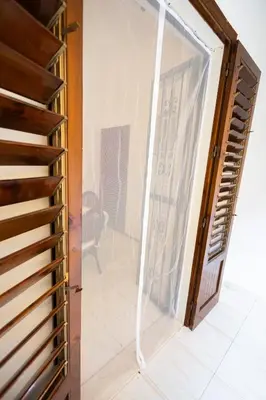 a sliding glass door in a room with a staircase at Plaza Del Mar Casa vacanza Mondello in Palermo