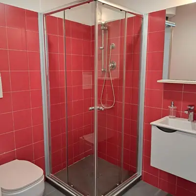 a red bathroom with a shower and a toilet at CasaLavinaro in Castellammare del Golfo