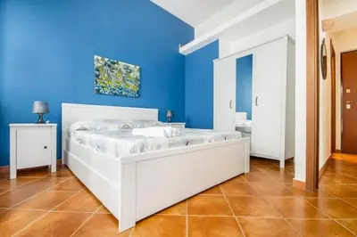 a large white bed in a blue room at La Casetta del Vicolo in Palermo