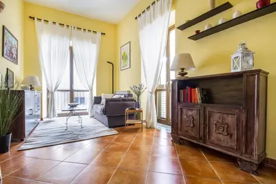 a living room with a couch and a book shelf at La Casetta del Vicolo in Palermo