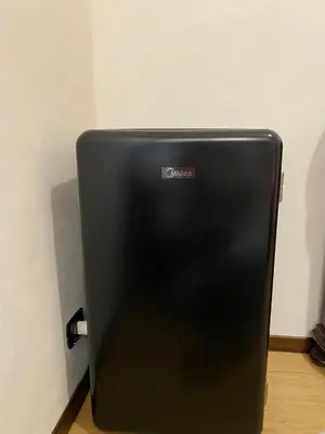 a black refrigerator with the word queen on it at B&B Duca di Maqueda nel pieno centro dell citta' a 5 minuti dalla stazione degli autobus e dei treni in Palermo