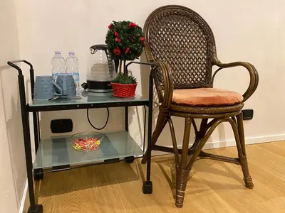a table with a chair and a table with water bottles at B&B Duca di Maqueda nel pieno centro dell citta' a 5 minuti dalla stazione degli autobus e dei treni in Palermo