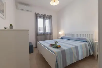 a bedroom with a bed with a bowl of fruit on it at Appartamento La Loggetta a pochi metri dalla spiaggia di San Vito Lo Capo in San Vito lo Capo
