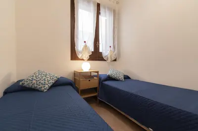 a bedroom with two beds and a window at Appartamento La Loggetta a pochi metri dalla spiaggia di San Vito Lo Capo in San Vito lo Capo