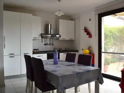 a kitchen with a table with a purple vase on it at Cale e Calle in Terrasini