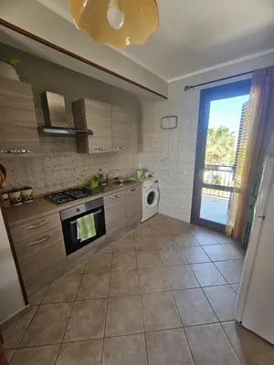 a kitchen with a sink and a stove top oven at David's Apartment in San Vito lo Capo