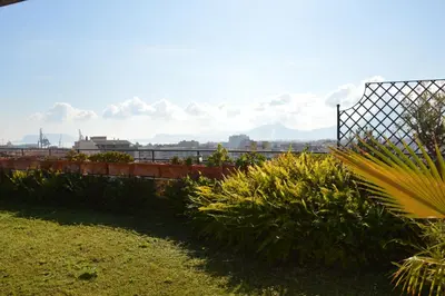 a garden with a fence and some plants at Appartamento con vista in Palermo