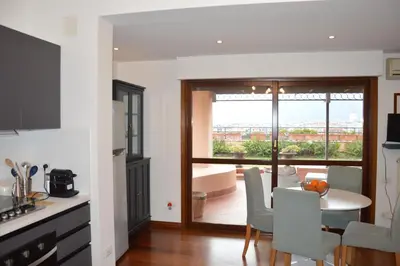a kitchen and dining room with a table and chairs at Appartamento con vista in Palermo