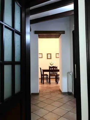 an open door to a dining room with a table at Apartment Via Vittorio Emanuele & Vucciria in Palermo