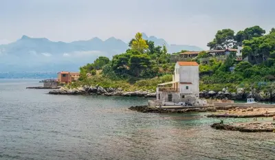 a small building in the middle of a body of water at Sunrise in Santa Flavia