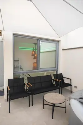 a living room with a couch and a table at Sunrise in Santa Flavia