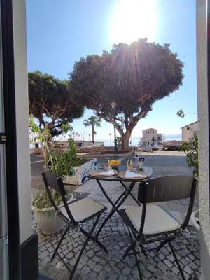 a table and two chairs sitting on a patio at Sunrise in Santa Flavia