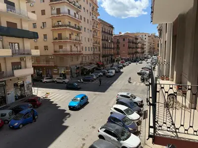 a row of cars parked in a street with buildings at Bart165 Luxury Rooms in Palermo