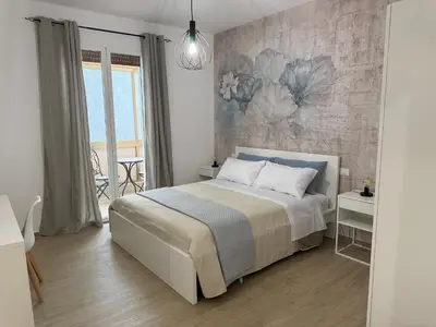 a bedroom with a bed and a brick wall at Bart165 Luxury Rooms in Palermo
