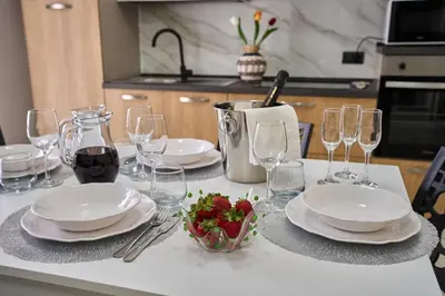 a table with a plate of strawberries and wine glasses at Harmony Lux in Bagheria