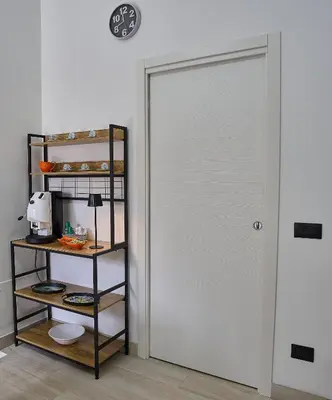 a sliding door in a room with a shelf at Harmony Lux in Bagheria