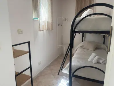 a bedroom with a bunk bed and a mirror at Arco Apartment in Bagheria