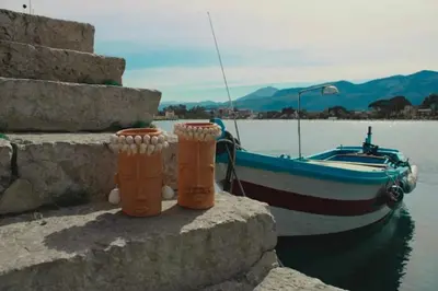 a boat sitting on the water next to a wall at Prospettiva Ballarò - Sotto la cupola in Palermo