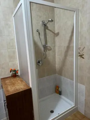 a shower with a glass door in a bathroom at Seaside in Santa Flavia