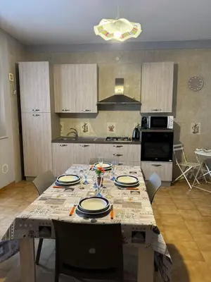 a kitchen with a table with plates on it at Seaside in Santa Flavia