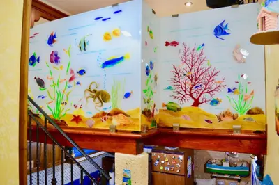 a room with a wall covered in aquariums at Home sweet home in Santa Flavia