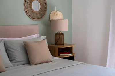 a bedroom with a bed with a lamp and a mirror at Donna Amalia villa in Mondello in Palermo