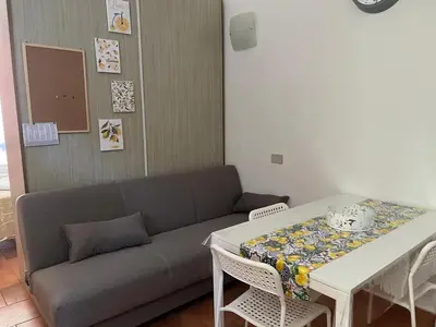 a living room with a couch and a table at Tampasiando Limoni in Cinisi