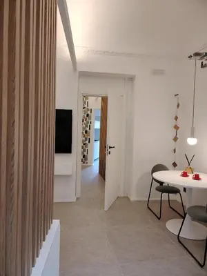 a living room with a table and a television at Cappuccetto Rosso Sweet Apartment Palermo in Palermo