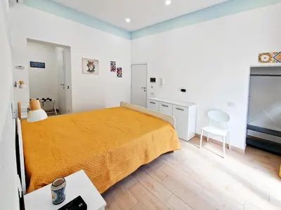 a bedroom with a bed and a television in it at Casa Mo' in Isola delle Femmine